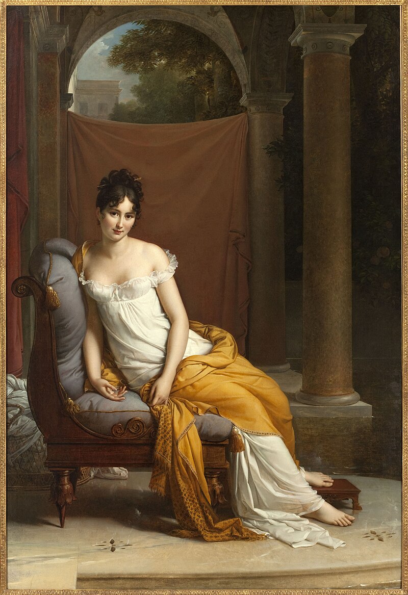 François Gérard, Juliette Récamier, olio su tela, 1802-1805, Parigi, Musée Carnavalet.<br>
Immagine in pubblico dominio, <a href=https://creativecommons.org/publicdomain/zero/1.0/deed.en>CC0 1.0</a>. Fonte: <a href=https://commons.wikimedia.org/wiki/File:Fran%C3%A7ois_G%C3%A9rard_-_Portrait_de_Juliette_R%C3%A9camier,_n%C3%A9e_Bernard_(1777-1849)_-_mus%C3%A9e_Carnavalet.jpg>Wikimedia Commons</a>.